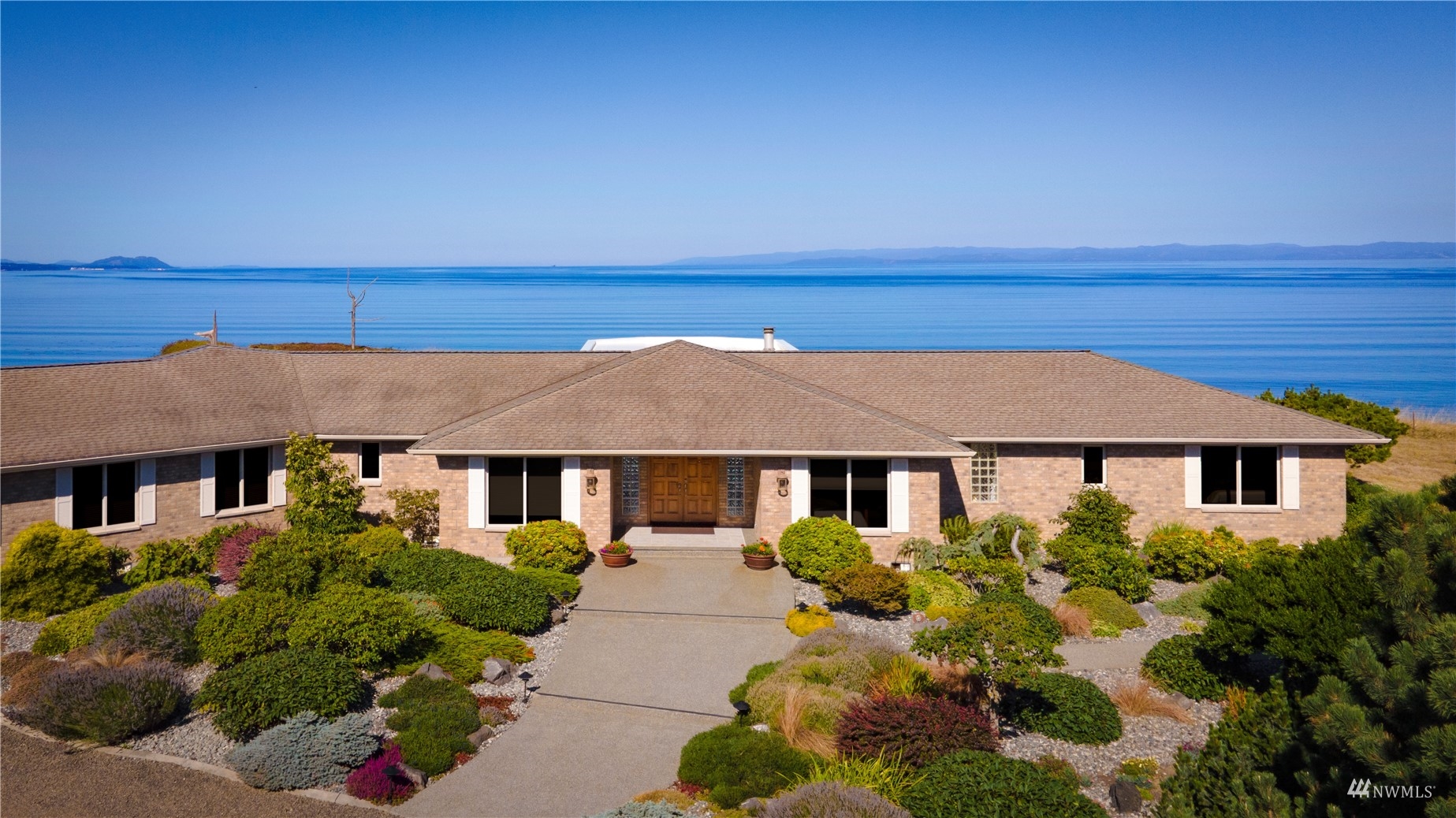 213 Mariners Point Road Sequim, WA 98382 - Photo 2 of 40 a front view of a house with a yard