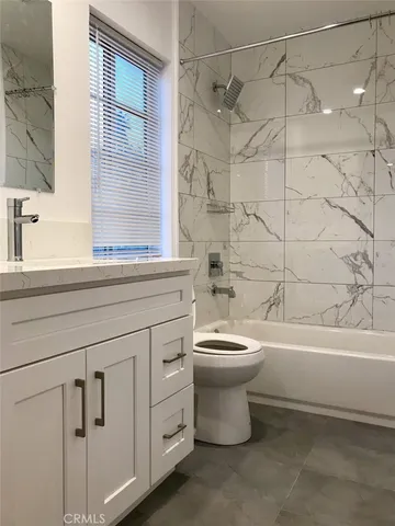a bathroom with a toilet a sink and bathtub