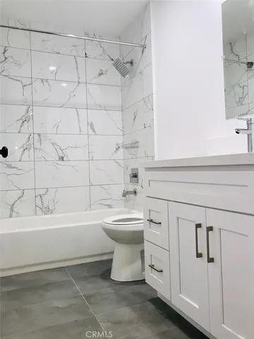 a bathroom with a sink a toilet and bathtub