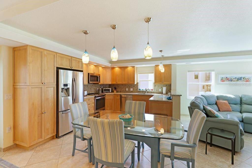 6154 Midnight Pass Road, Unit 201 Sarasota, FL 34242 - Photo 3 of 11 a view of a dining room with furniture window and wooden floor