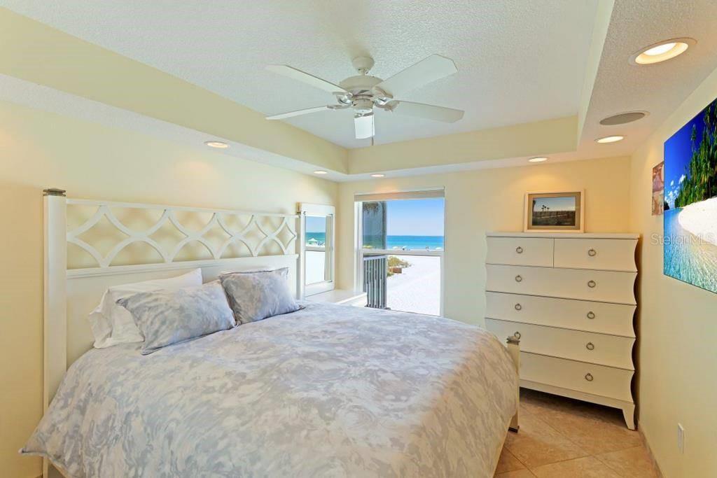 6154 Midnight Pass Road, Unit 201 Sarasota, FL 34242 - Photo 7 of 11 a bedroom with a bed and a dresser
