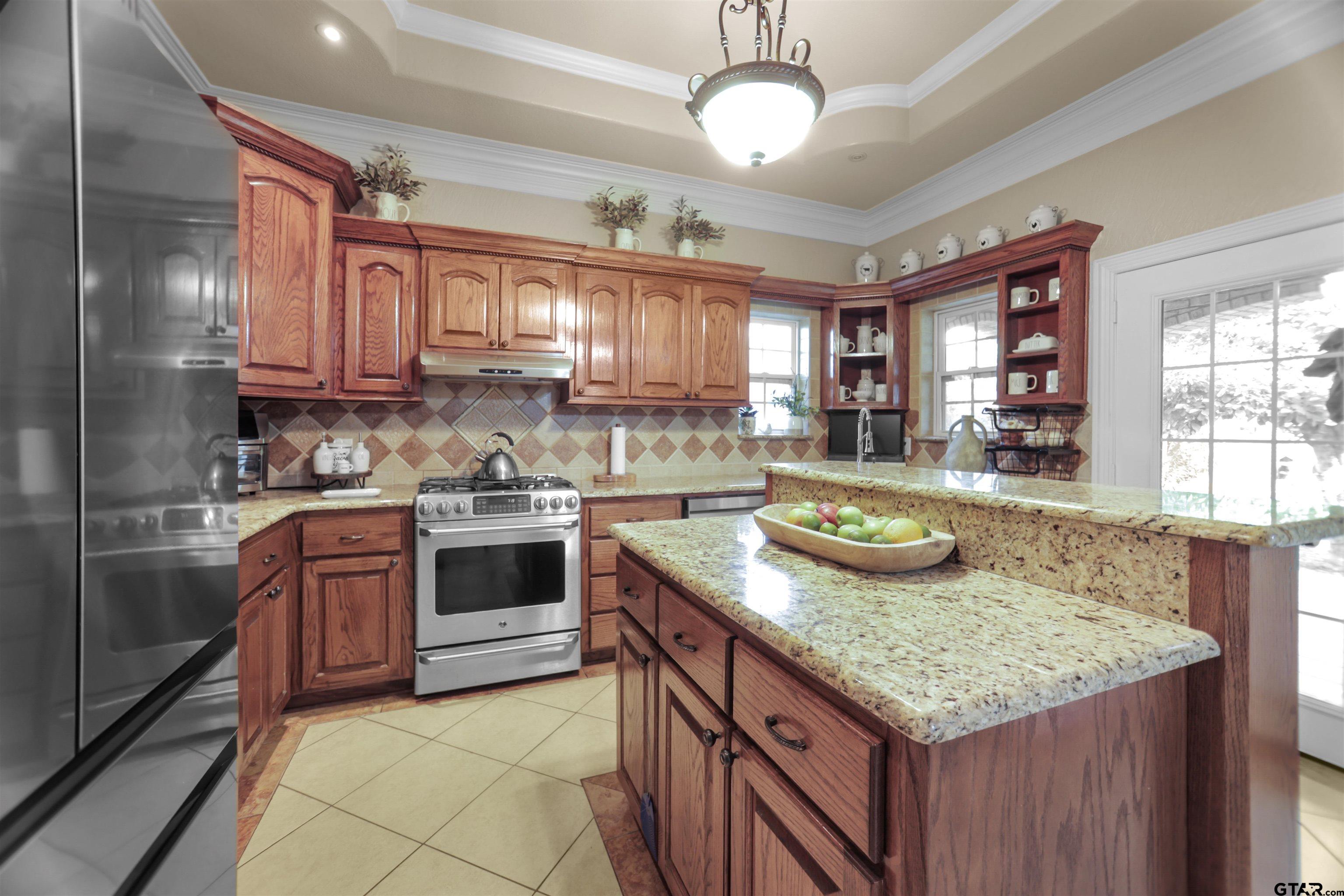 11931 State Highway 64 Tyler, TX 75704 - Photo 23 of 44 a kitchen with kitchen island granite countertop a sink and counter space