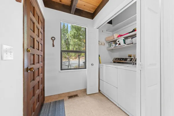 a room with white cabinets and a window