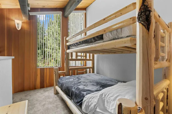 a bedroom with a bed next to a window