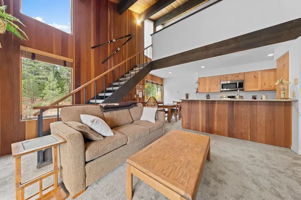 a living room with furniture a large window