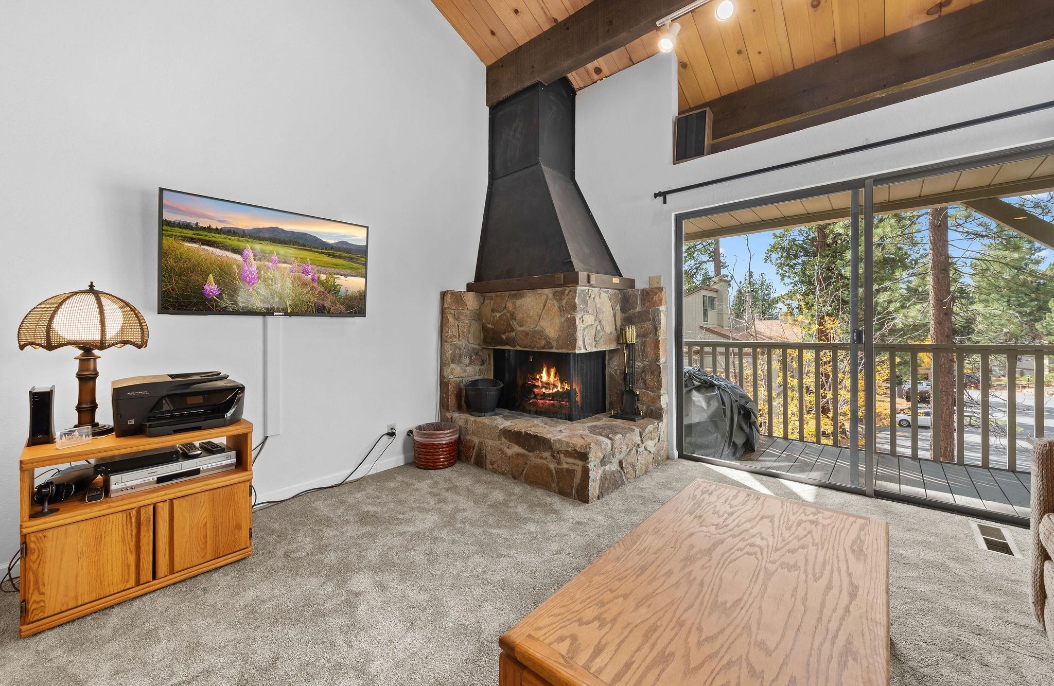 1001 Commonwealth Drive, Unit 206 Kings Beach, CA 96143 - Photo 4 of 28 a bedroom with furniture and a fireplace