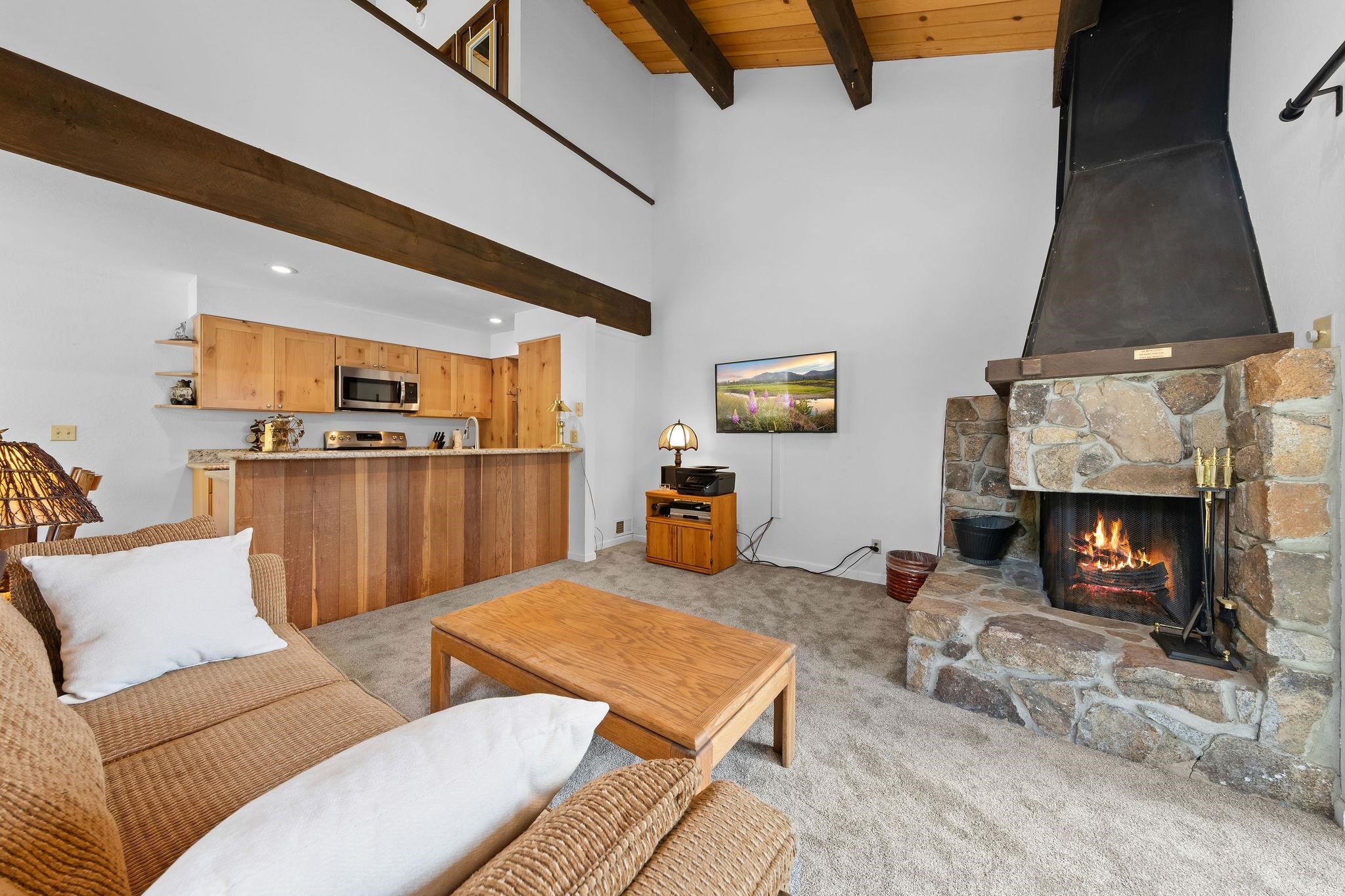 1001 Commonwealth Drive, Unit 206 Kings Beach, CA 96143 - Photo 5 of 28 a living room with furniture and a fireplace