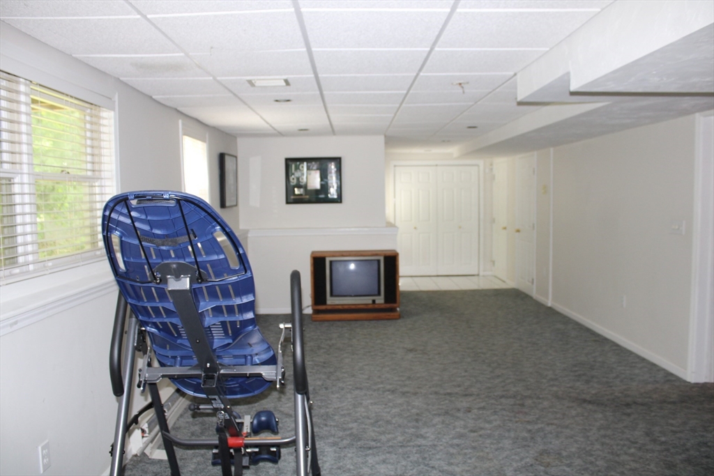 27 Gretchen Way Raynham, MA 02767 - Photo 15 of 20 a living room with furniture a flat screen tv and a window