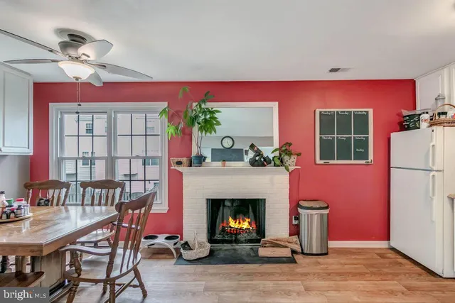 a living room with furniture a window and a fireplace
