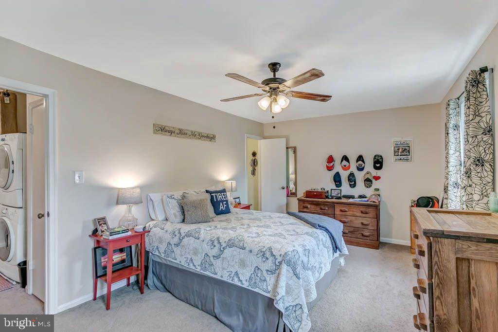 1677 Brice Court Crofton, MD 21114 - Photo 19 of 34 a bedroom with a bed and a chandelier