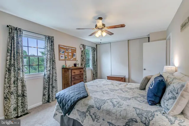 a bedroom with a large bed and a window