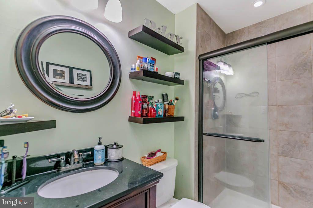 1677 Brice Court Crofton, MD 21114 - Photo 22 of 34 a bathroom with a sink a mirror and a shower