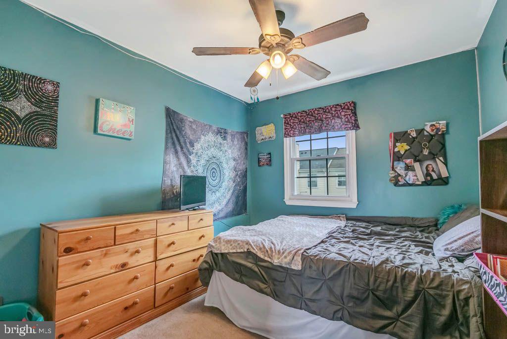 1677 Brice Court Crofton, MD 21114 - Photo 24 of 34 a bedroom with a bed and a chandelier