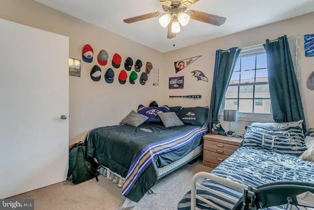 a bedroom with two beds and a window