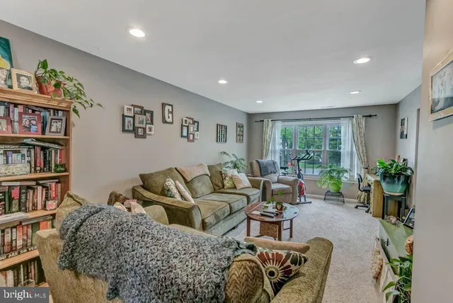 a living room with furniture and a book shelf