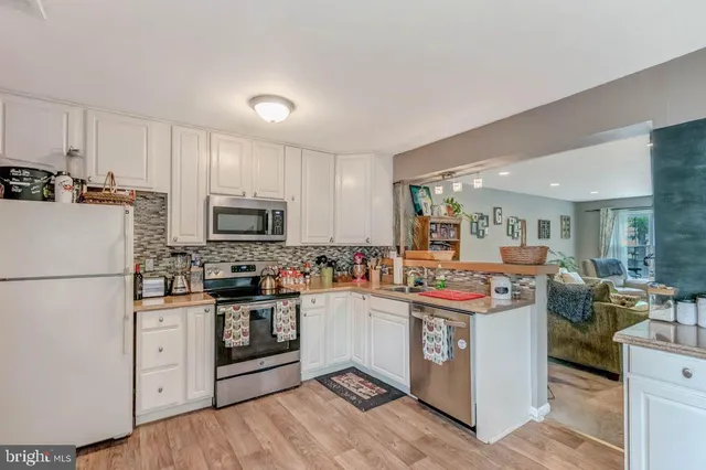 a kitchen with stainless steel appliances granite countertop a stove and a refrigerator