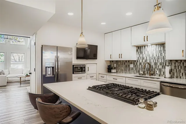a kitchen that has a stove and a wooden floor