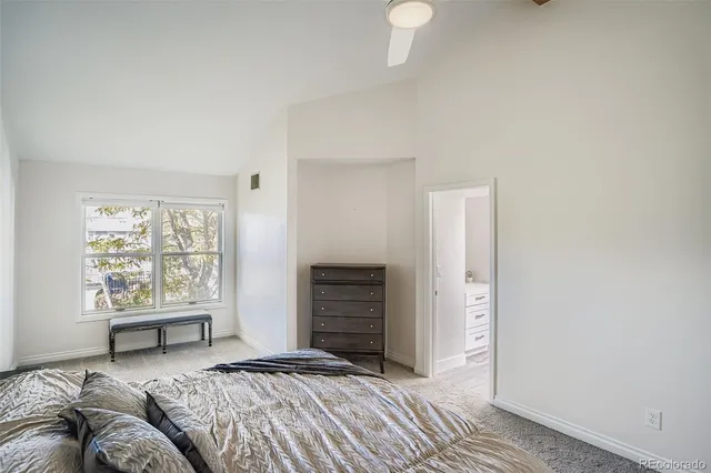 a bedroom with a bed and a night stand