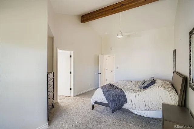 a spacious bathroom with a granite countertop double vanity sink a mirror and a bathtub