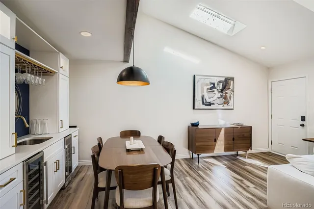 a living room with furniture a fireplace and a large mirror