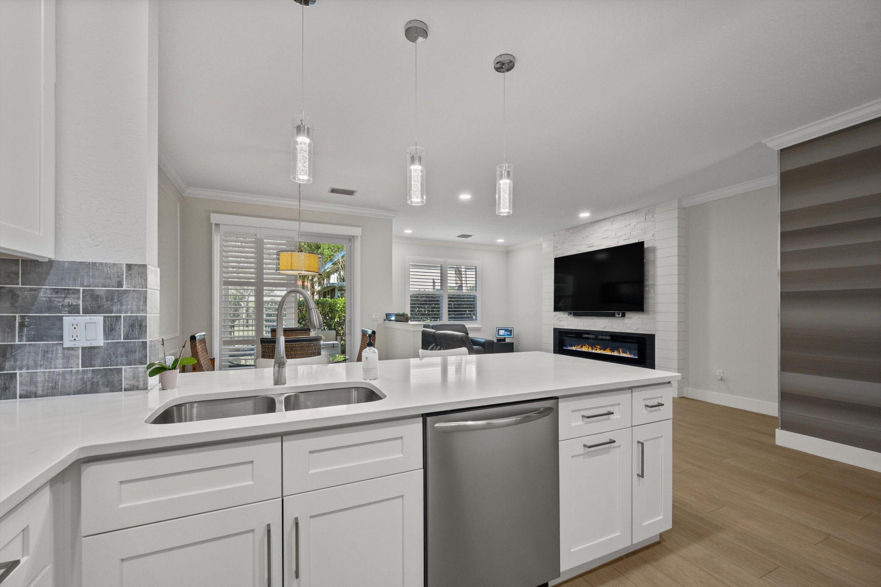 6058 Seminole Gardens Circle Riviera Beach, FL 33418 - Photo 11 of 47 a kitchen with a sink and a large mirror