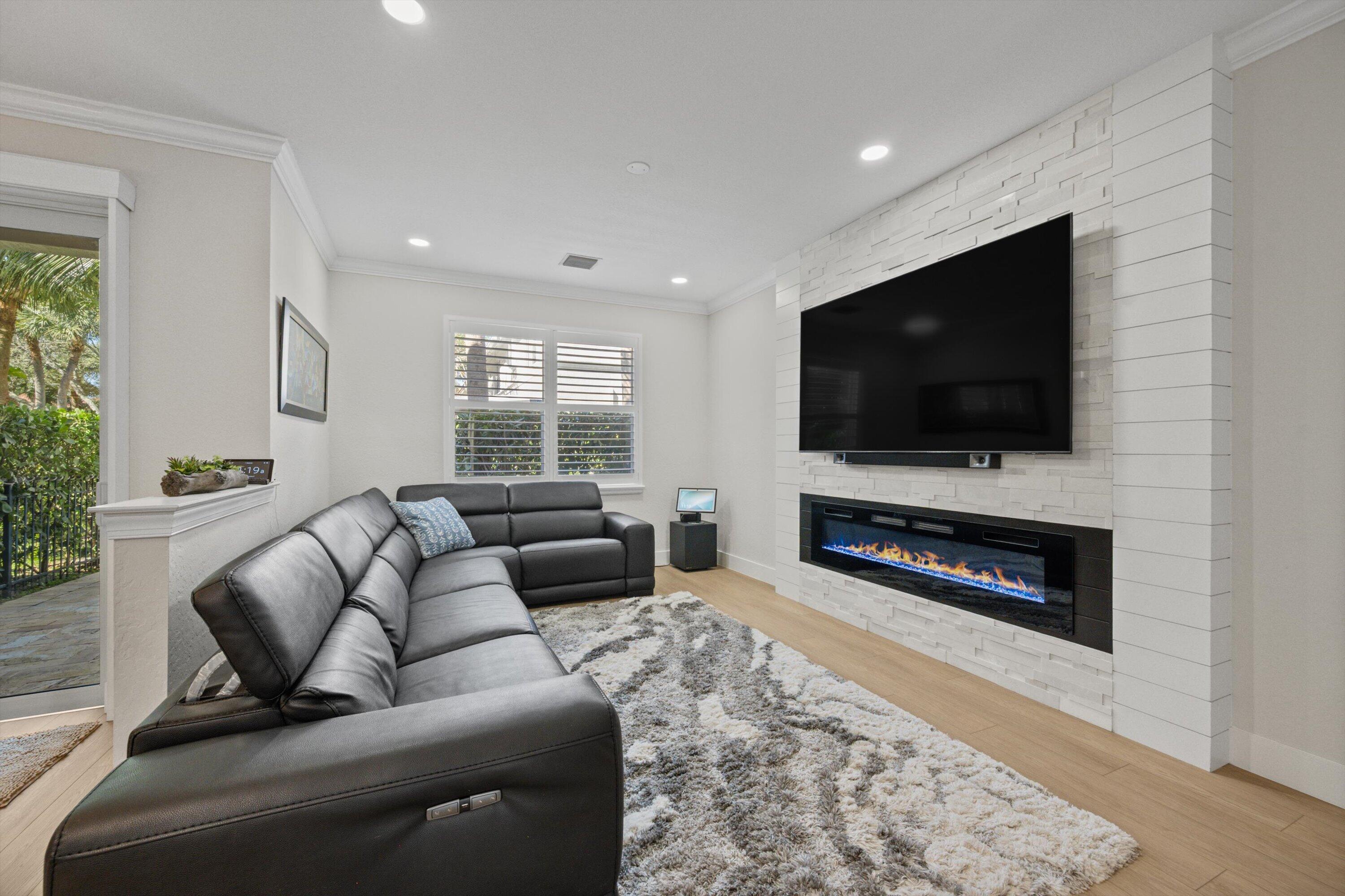 6058 Seminole Gardens Circle Riviera Beach, FL 33418 - Photo 13 of 47 a living room with furniture and a flat screen tv