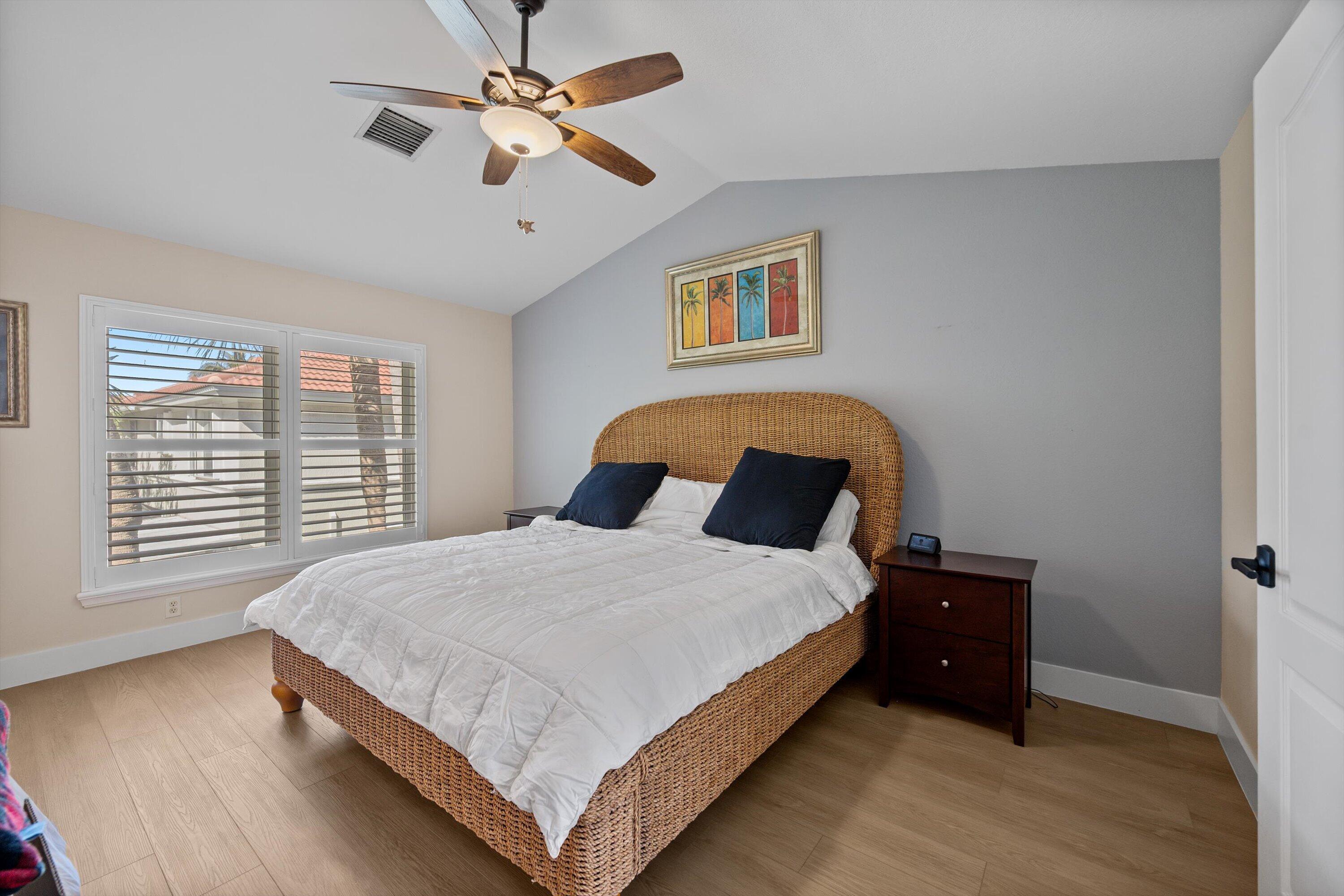 6058 Seminole Gardens Circle Riviera Beach, FL 33418 - Photo 20 of 47 a bedroom with a bed and a ceiling fan