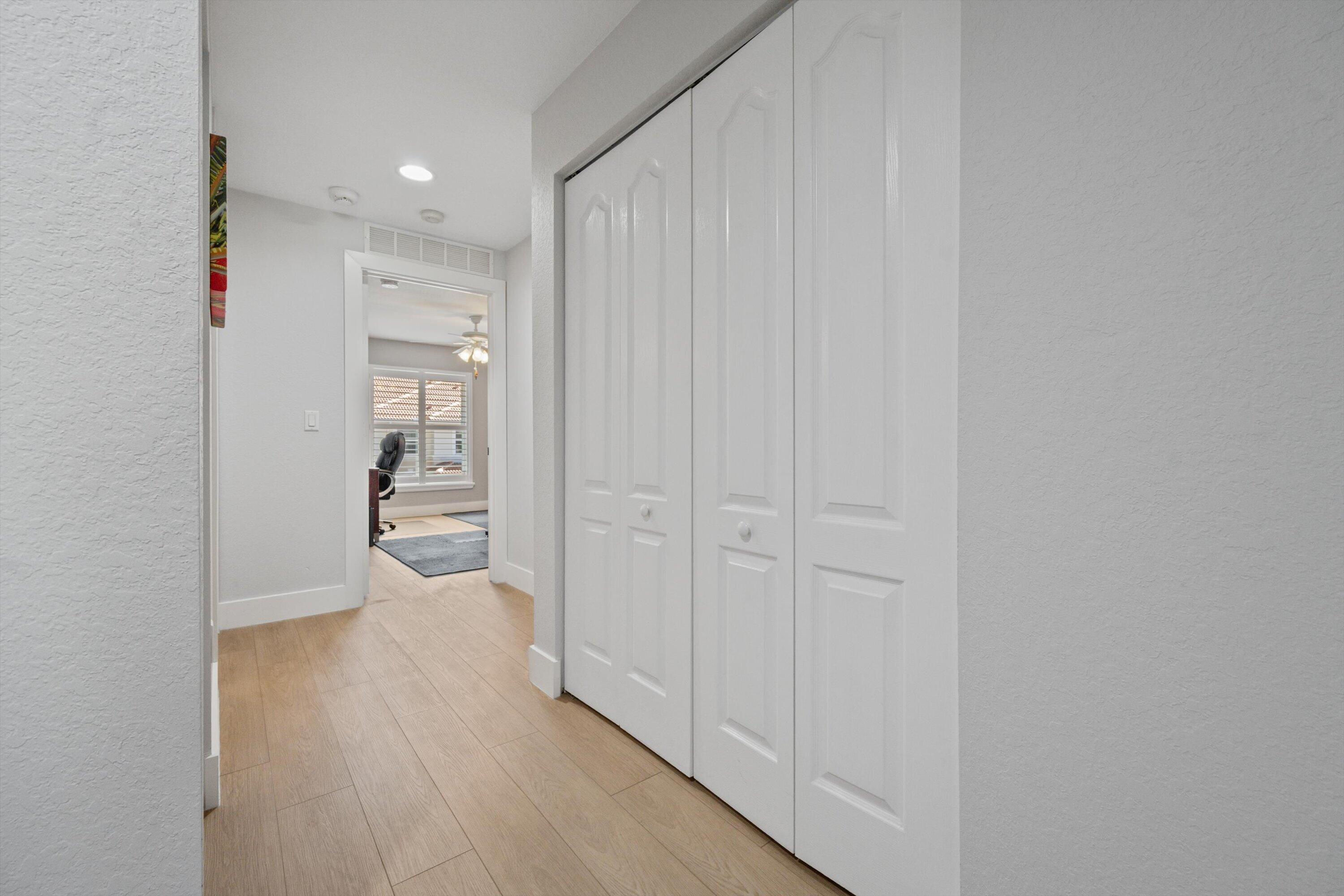 6058 Seminole Gardens Circle Riviera Beach, FL 33418 - Photo 23 of 47 a view of a hallway with wooden floor