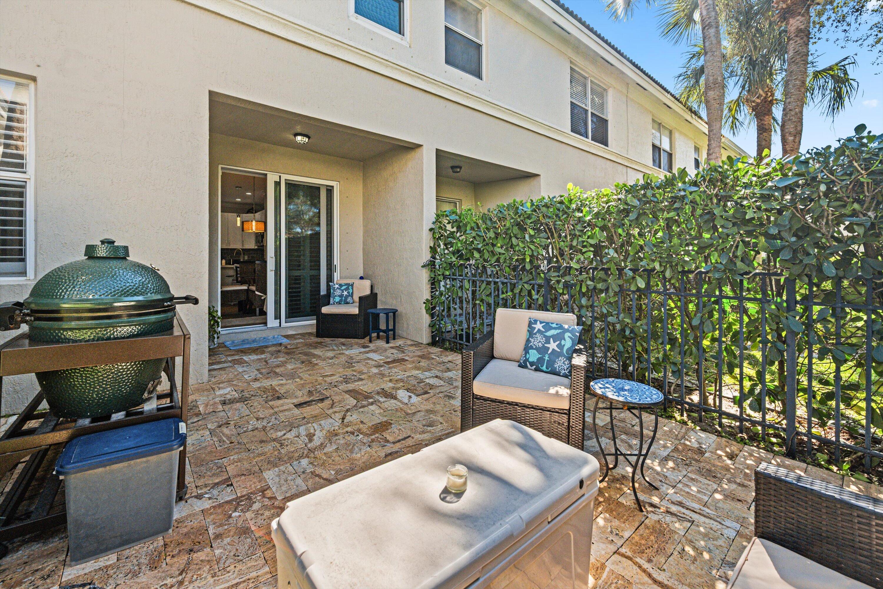 6058 Seminole Gardens Circle Riviera Beach, FL 33418 - Photo 29 of 47 a view of a chairs and table in the patio