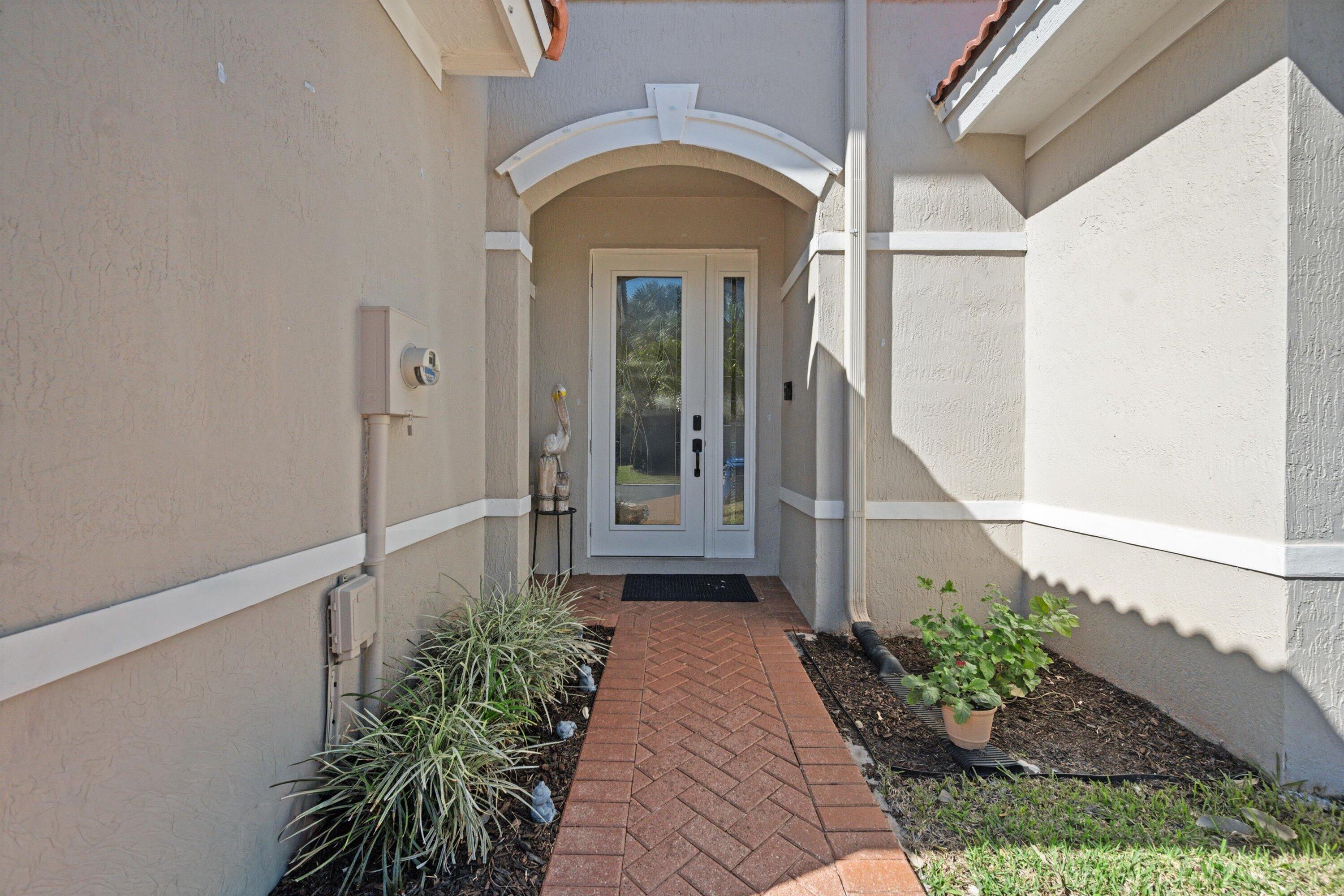 6058 Seminole Gardens Circle Riviera Beach, FL 33418 - Photo 3 of 47 a view of entrance door of the house