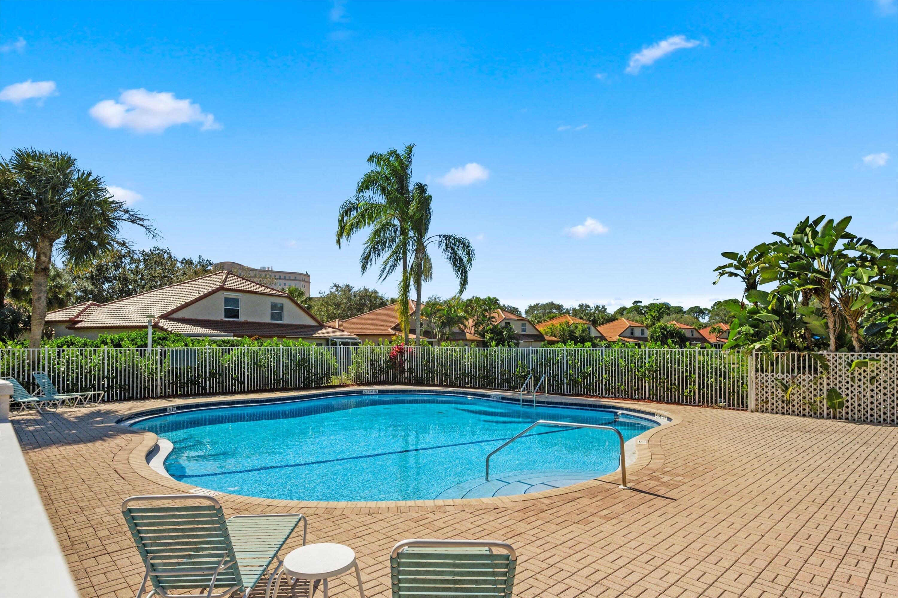 6058 Seminole Gardens Circle Riviera Beach, FL 33418 - Photo 32 of 47 a view of a backyard and a swimming pool