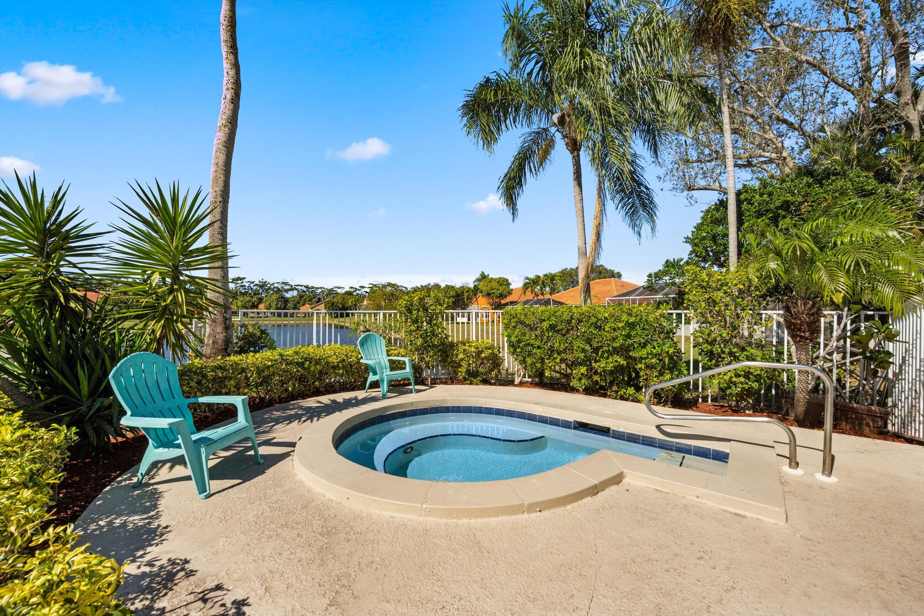 6058 Seminole Gardens Circle Riviera Beach, FL 33418 - Photo 33 of 47 a view of a swimming pool with a patio and a garden