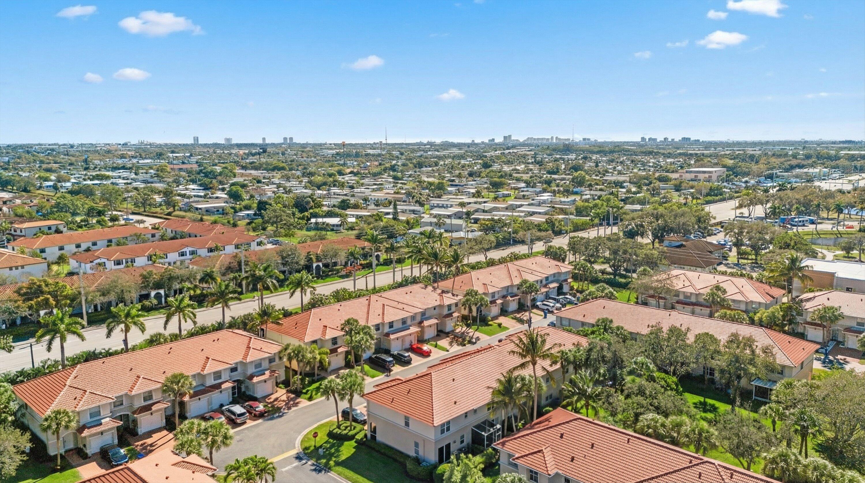 6058 Seminole Gardens Circle Riviera Beach, FL 33418 - Photo 46 of 47 an aerial view of residential houses with outdoor space
