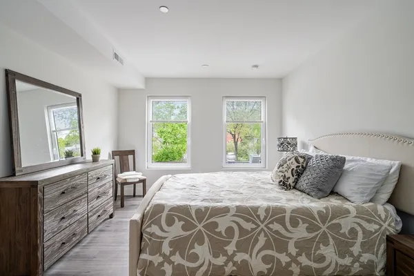 a bedroom with a large bed and a window