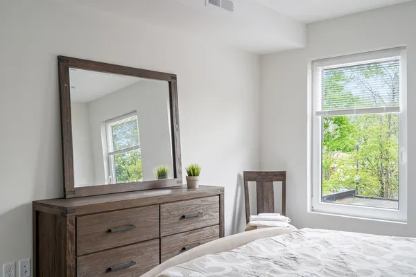 a bedroom with a bed and a window