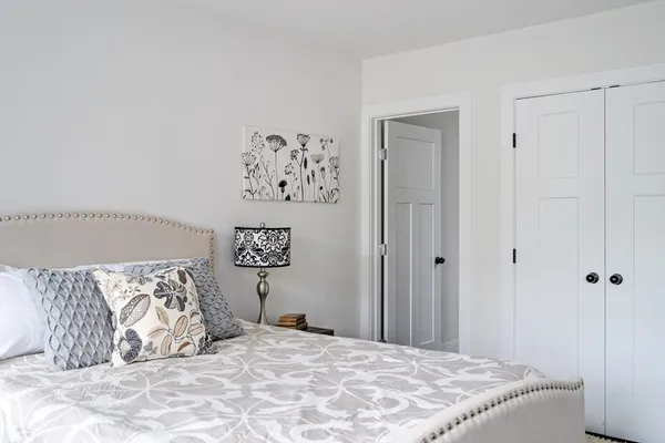 a bedroom with a large bed and a couch