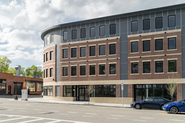 a front view of a building with parking space