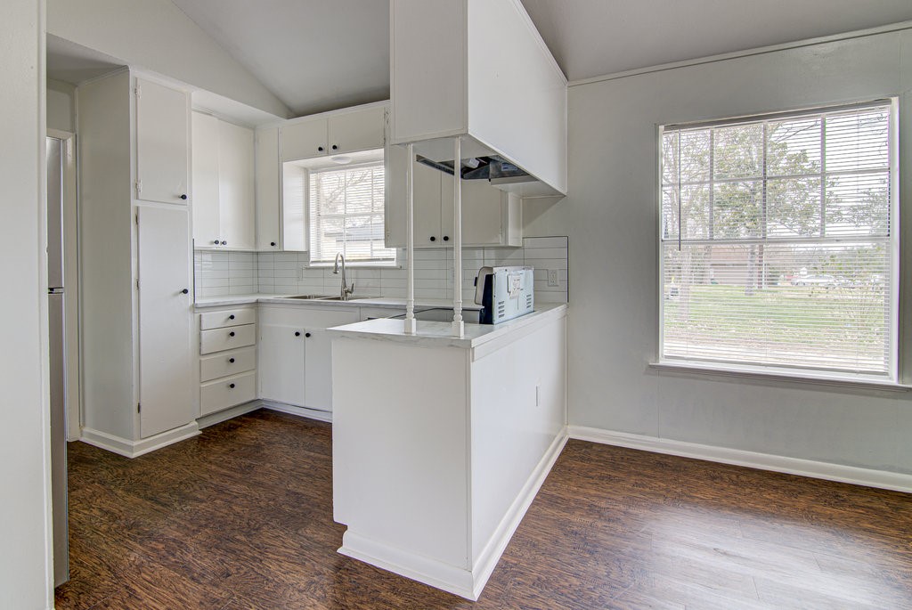 5703 Gloucester Lane, Unit A Austin, TX 78723 - Photo 3 of 11 a kitchen with cabinets oven and a sink