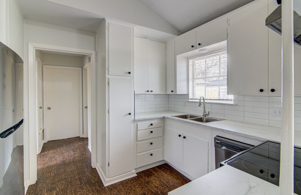 5703 Gloucester Lane, Unit A Austin, TX 78723 - Photo 4 of 11 a kitchen with white cabinets and white appliances