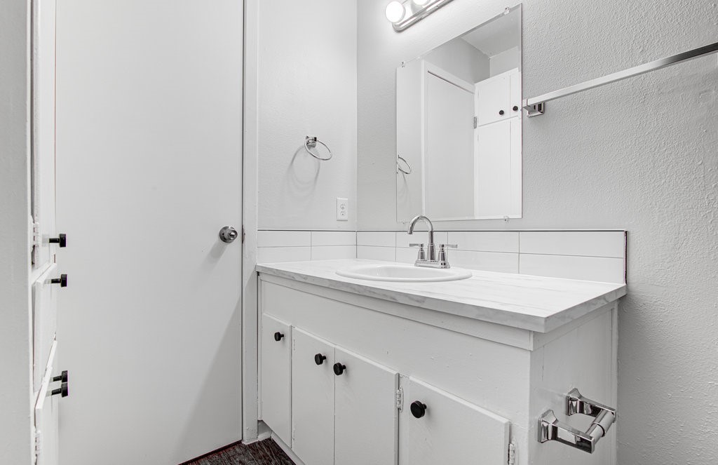 5703 Gloucester Lane, Unit A Austin, TX 78723 - Photo 7 of 11 a bathroom with a sink and a mirror