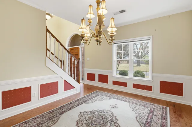 a view of an entryway with wooden floor