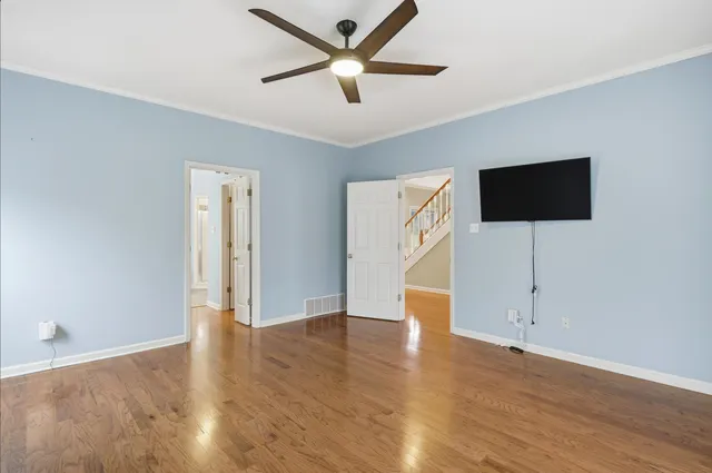 a view of an empty room with wooden floor