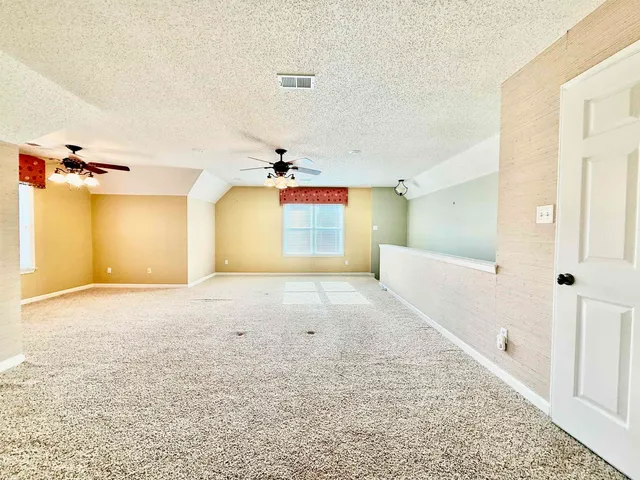 a view of yard with wooden fence