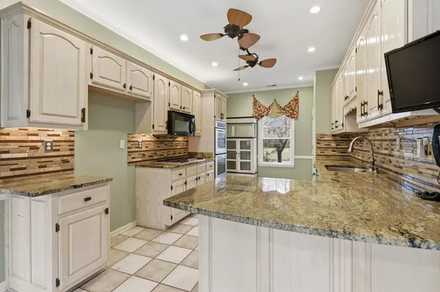 a kitchen with stainless steel appliances granite countertop a stove oven and a refrigerator