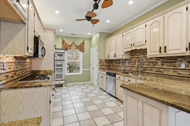 a kitchen with stainless steel appliances a stove sink and cabinets