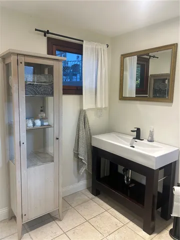 a bathroom with a sink a mirror and a shower