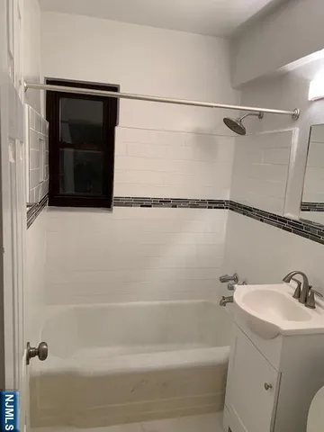 a bathroom with a shower and a sink