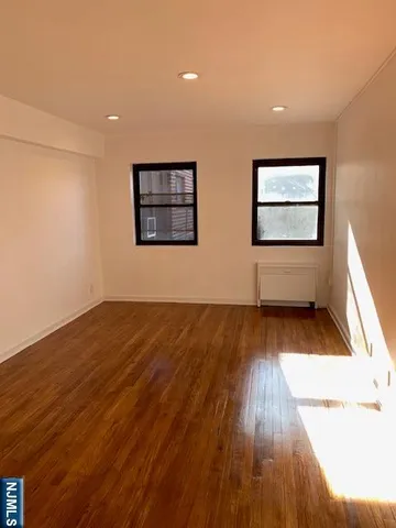 a view of workspace with wooden floor and windows