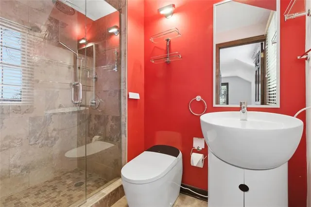 a bathroom with a sink toilet and shower