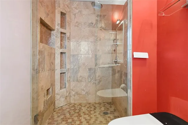 a bathroom with a shower and a toilet